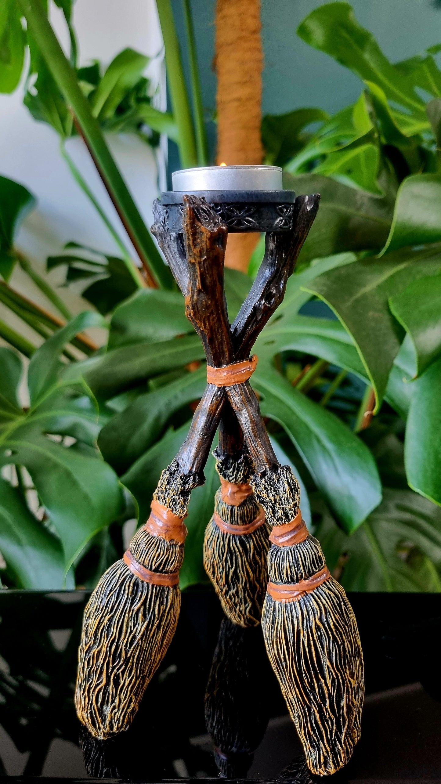 Witch's broom candle holder